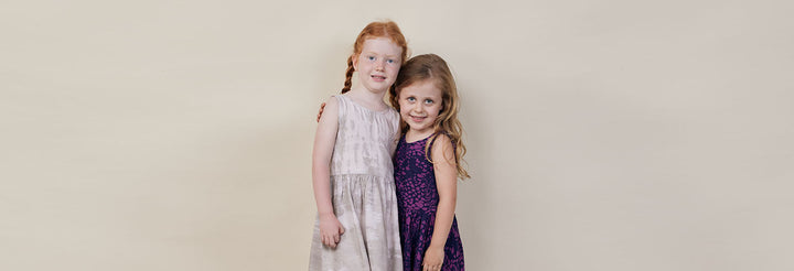 batik dresses for kids as two models in modern batik in colors purple and pastel