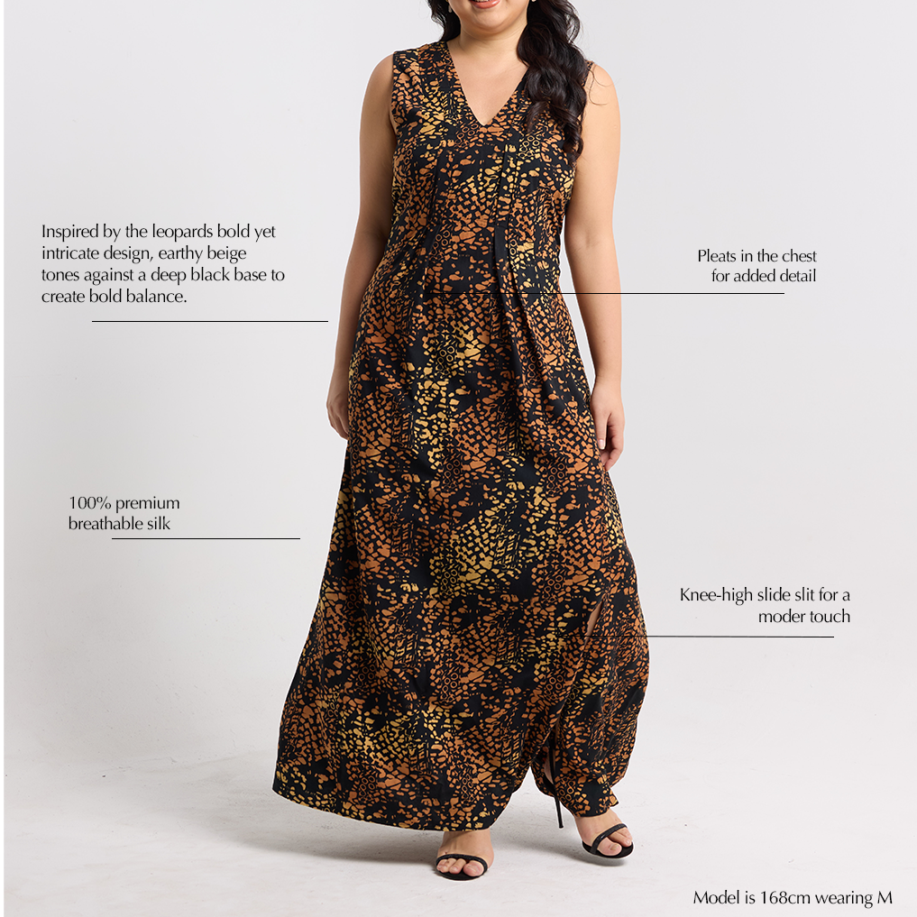 Close-up of Batik Boutique’s Black Leopard Silk Maxi Dress with pleated chest detailing, knee-high slit, and breathable 100% silk fabric. Inspired by leopard motifs with hand-blocked batik patterns in beige and black