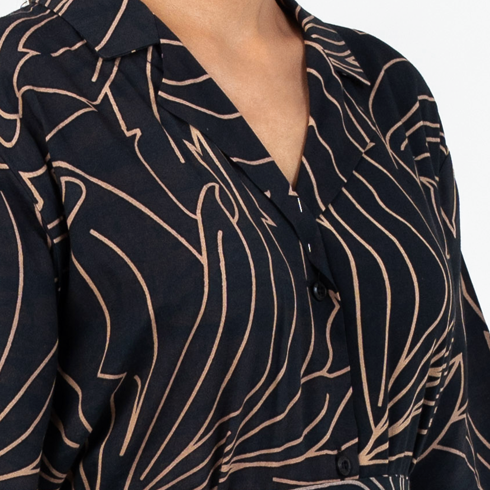 Close-up of Batik Boutique’s Onyx Palma Button-Up Dress showing fine batik-inspired linework and wooden button detailing
