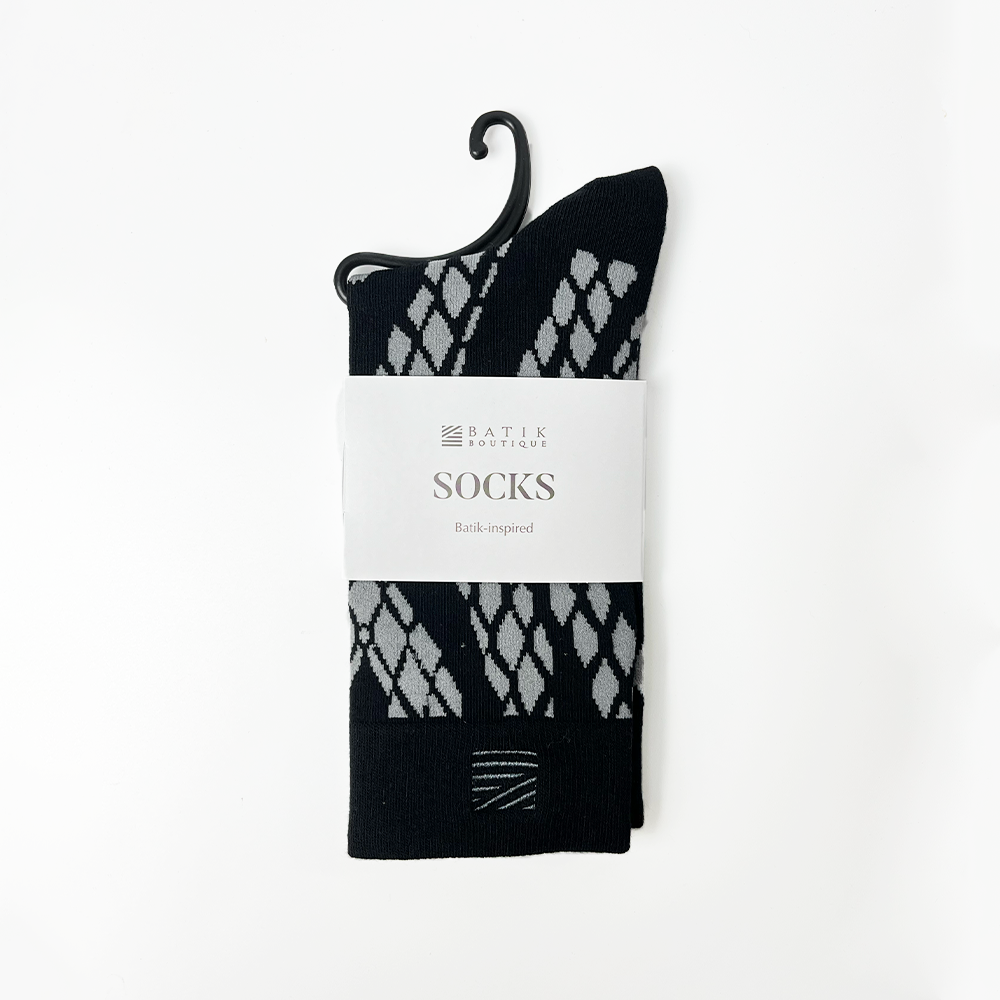a batik inspired black snakeskin against a white background socks