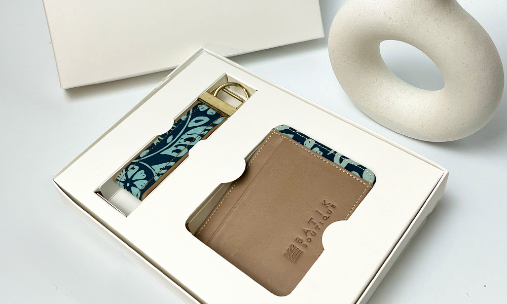 a lifestyle photo of travel set in the pattern teal ukir against a white background in a box