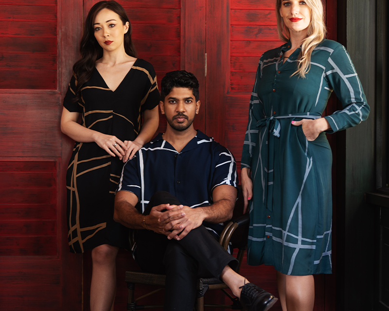 two woman and one man in batik sustainable clothing