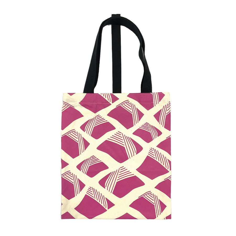 A batik totebag or even a shopping bag with pattern inspired from Nasi Lemak in fuchsia color and put on a white background. This photo show the back side of the bag