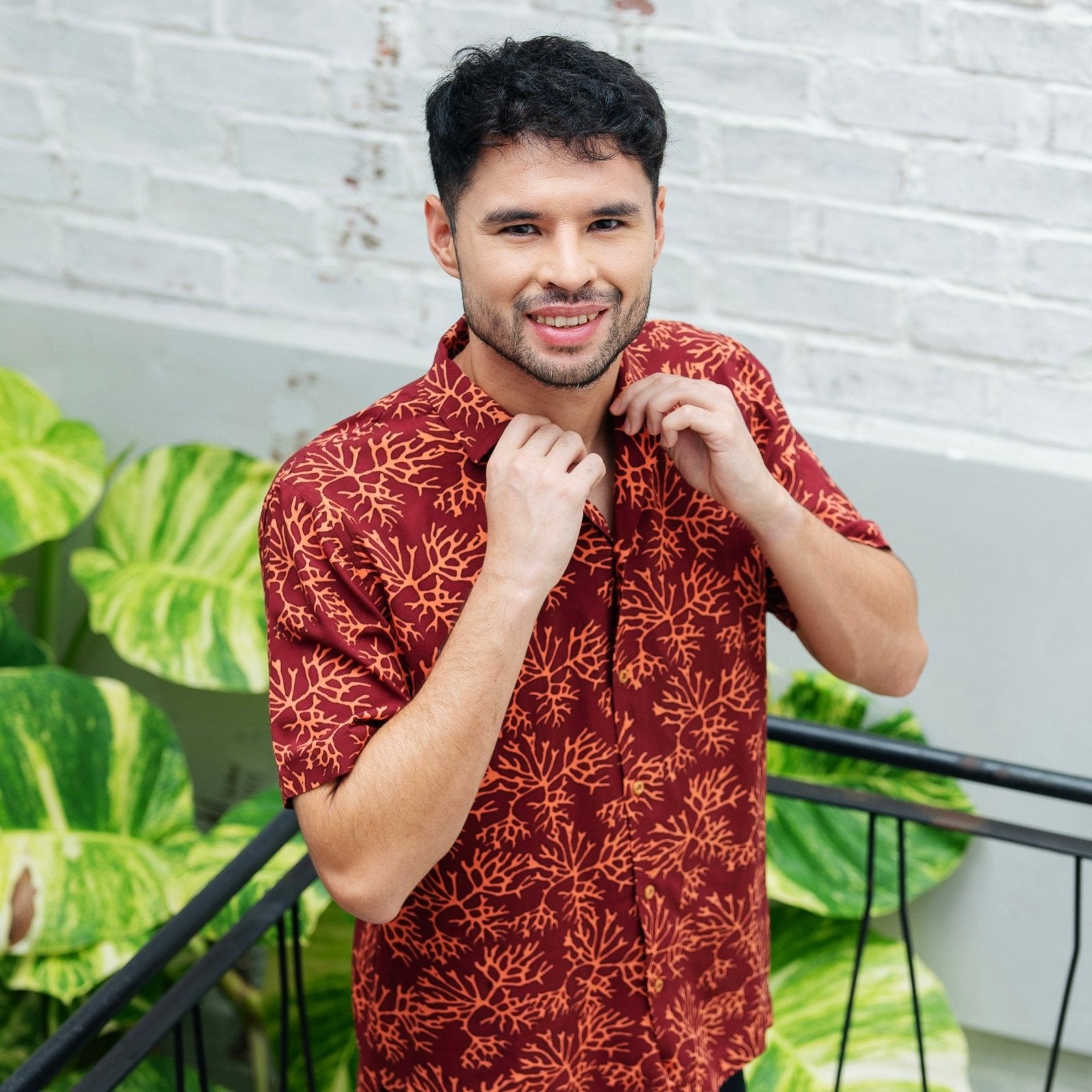 model wearing  Maroon Coral men's short sleeve shirt 