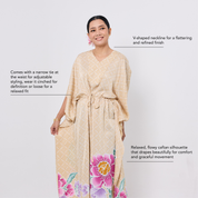 Woman wearing a beige floral dress with text describing its features on a white background