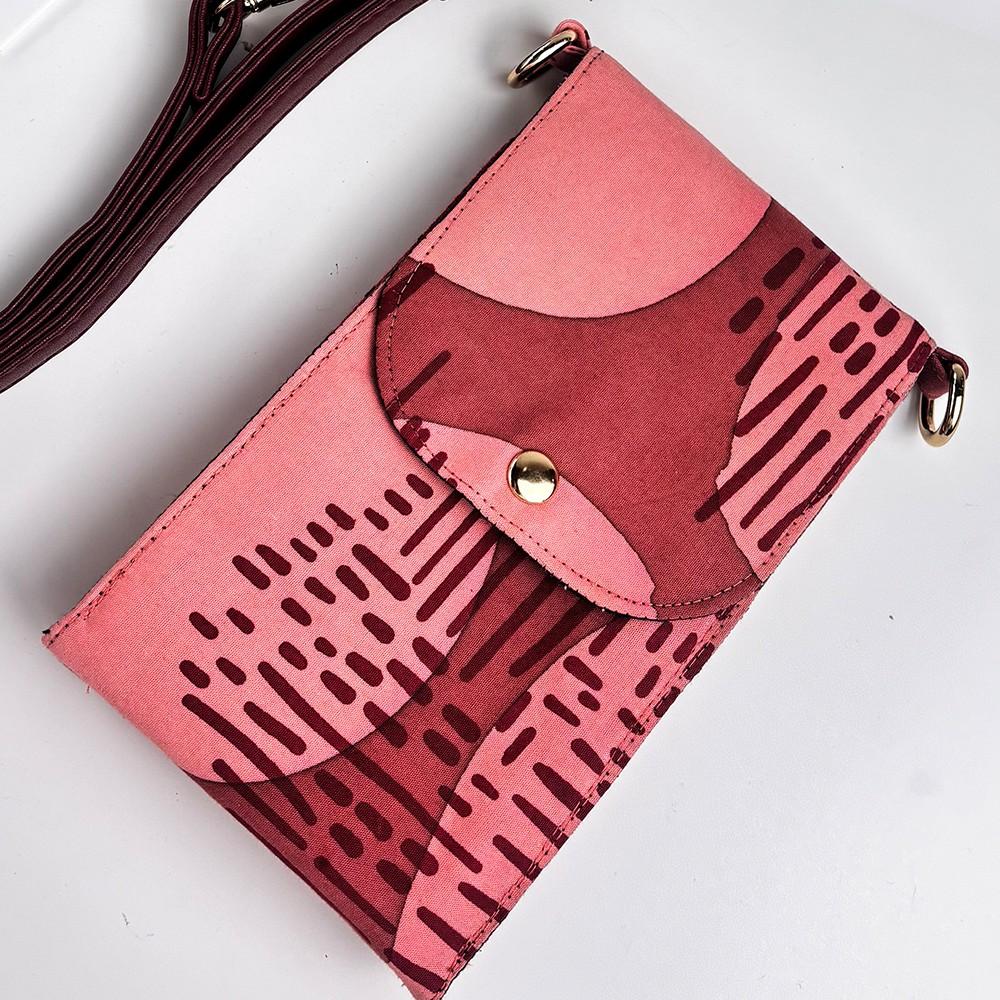 Pink handbag with a unique pattern on a white background