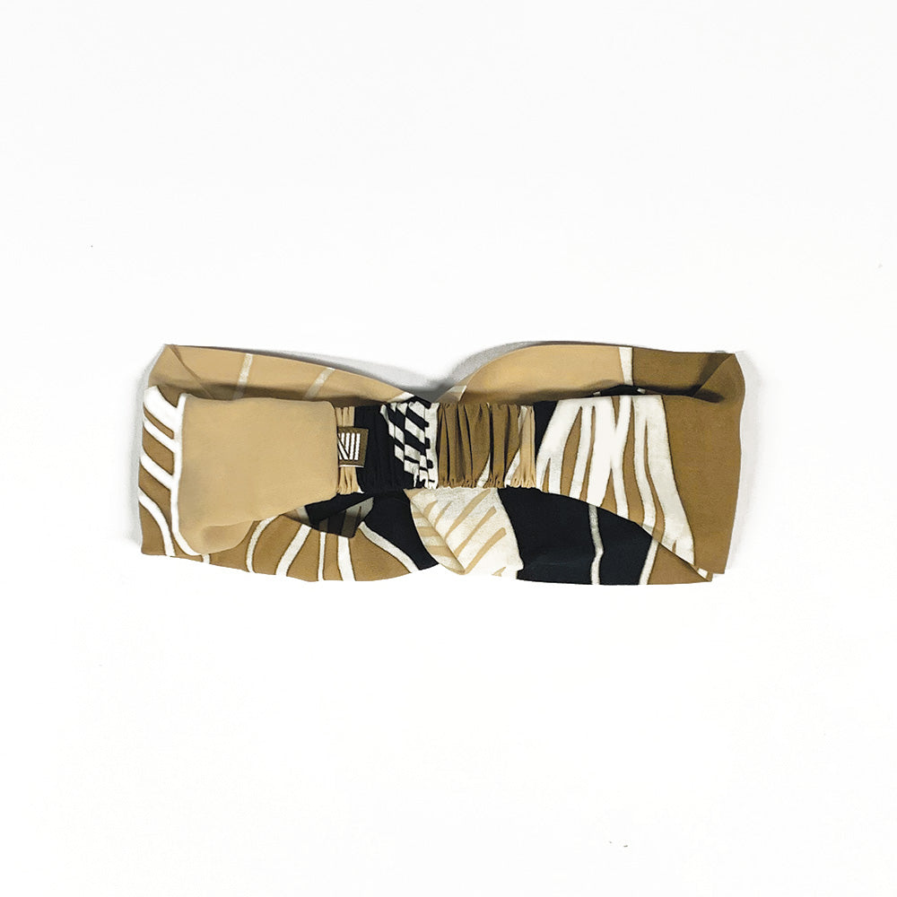 a whitebox photo of a midnight bukit headband made from remnants of batik showcasing the details on the back of the headband