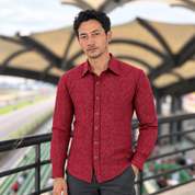 Man wearing red batik shirt outside