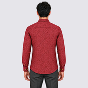 man wearing red batik shirt facing the back