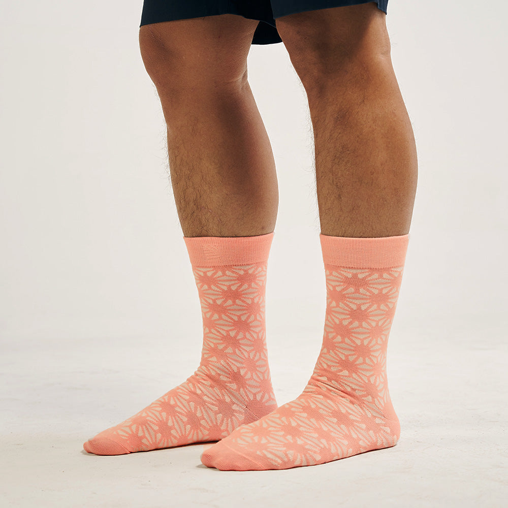 A model wearing batik-inspired socks in peach fireworkprint