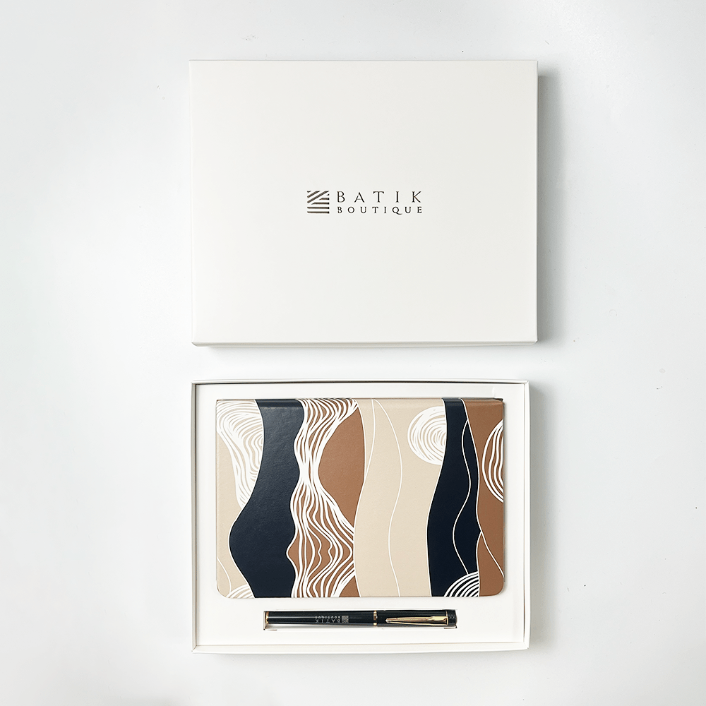 Notebook with pen set in a decorative box, branded 'Batik Boutique'.