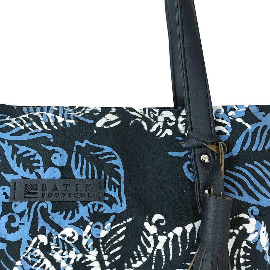 a whitebox photo of batik tote bag in blue nautical fern. It's a close up photo of the bag showing the material