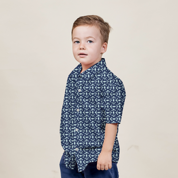a young model posing against a neutral background in an authentic batik shirt in the pattern navy kompas