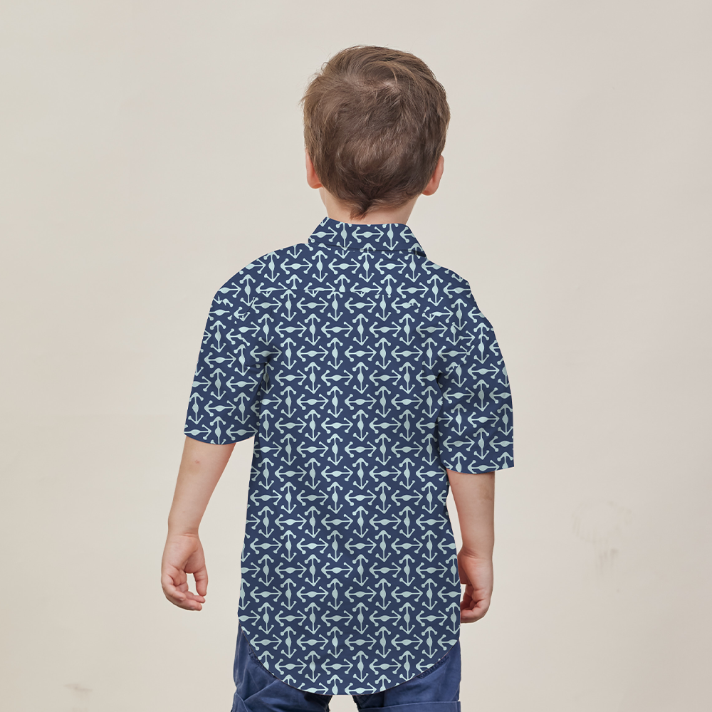 a young model posing against a neutral background to showcase the batik shirt in the pattern navy kompas