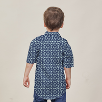 a young model posing against a neutral background to showcase the batik shirt in the pattern navy kompas