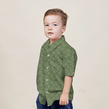 a boy posing in an authentic batik shirt in the pattern olive bintang against a neutral background