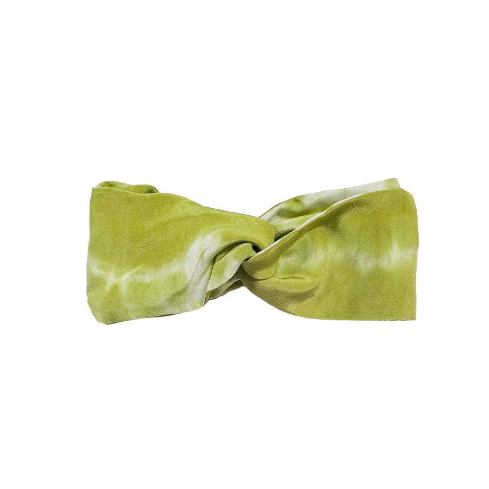 a white flatlay of shibori headband in olive
