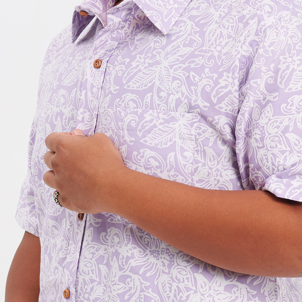 a close up shot of a male model wearing an authentic batik shirt in the pattern lilac floret
