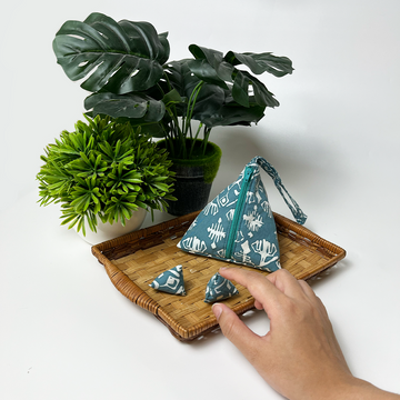 a lifestyle photo with the batu seremban made of batik as the focus in the pattern turquoise tikar