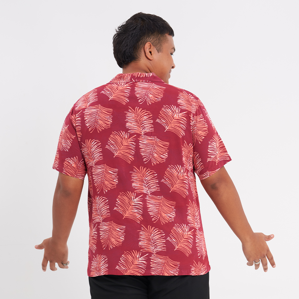 a male model with his back to the camera to showcase the details on the back of the shirt in the pattern crimson sawit