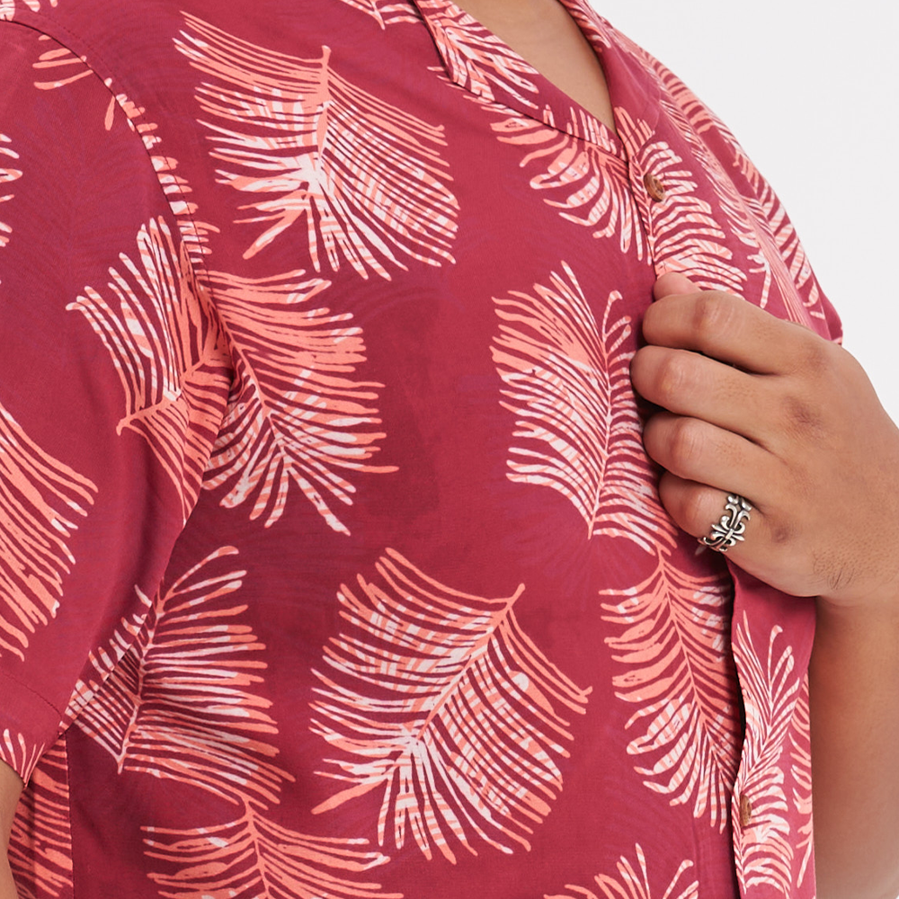 a closeup shot of a male model wearing a batik shirt in the pattern crimson sawit showcasing the details on it