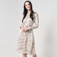 A woman striking a pose in a Shibori Long Shirt Dress, set against a neutral background, showcasing the elegant design and vibrant pattern
