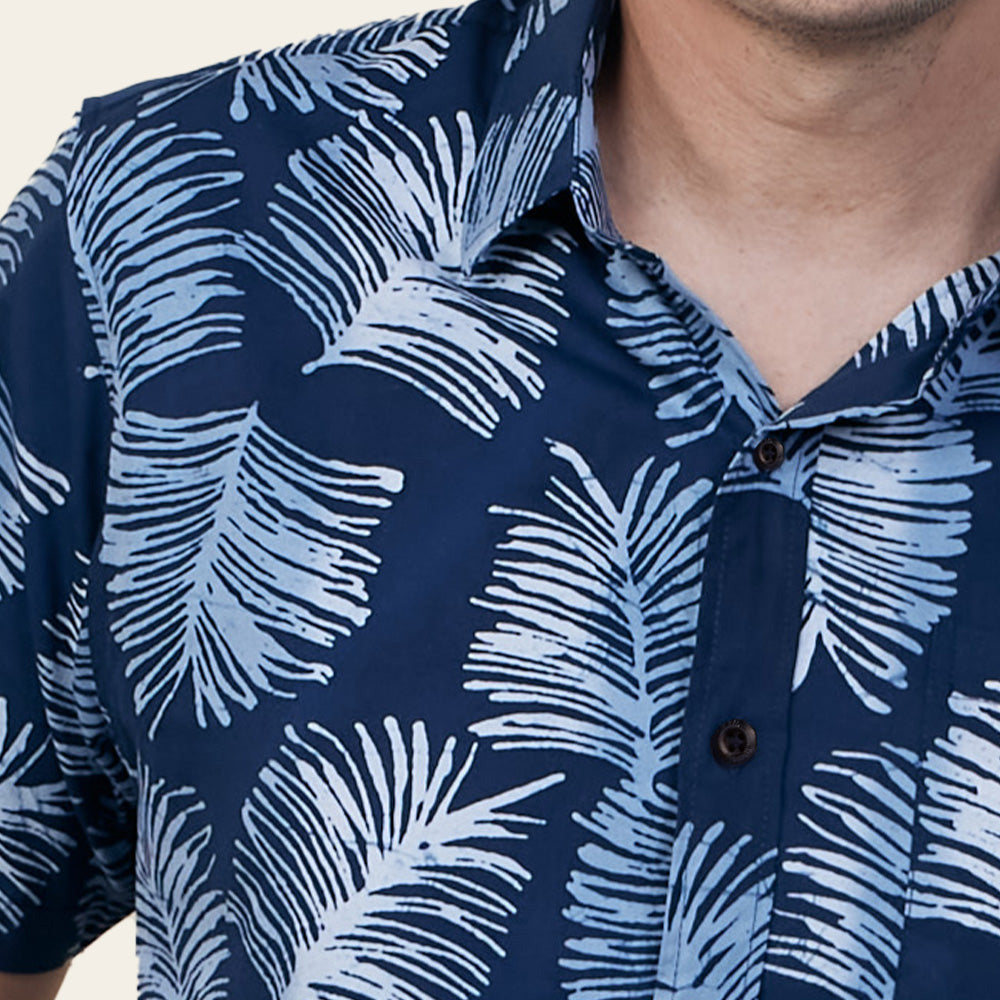 a closeup authentic batik shirt in navy sawit against a neutral background