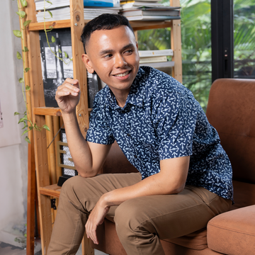 a male model posing in front of a lifestyle background in a batik shirt in the pattern navy kompas