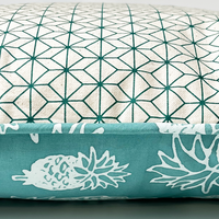 a photo showcasing the reversible print on the batik pillow against a white background
