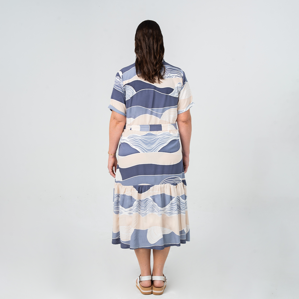 Back view of Batik Boutique’s Button-Up Dress in Lavender Bukit print, featuring a relaxed fit and tiered skirt.