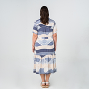 Back view of Batik Boutique’s Button-Up Dress in Lavender Bukit print, featuring a relaxed fit and tiered skirt.
