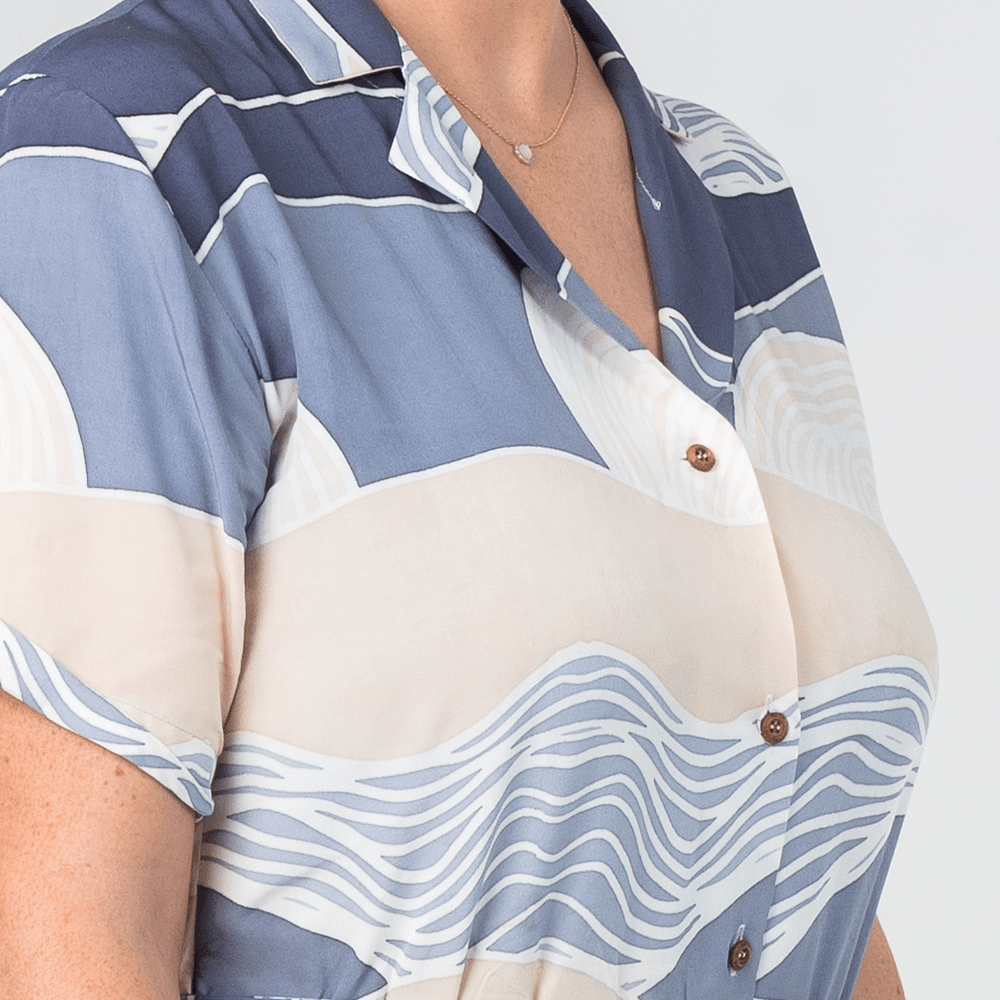 lose-up of Batik Boutique’s Button-Up Dress in Lavender Bukit print, highlighting durable wooden buttons and soft cotton fabric.