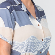 lose-up of Batik Boutique’s Button-Up Dress in Lavender Bukit print, highlighting durable wooden buttons and soft cotton fabric.