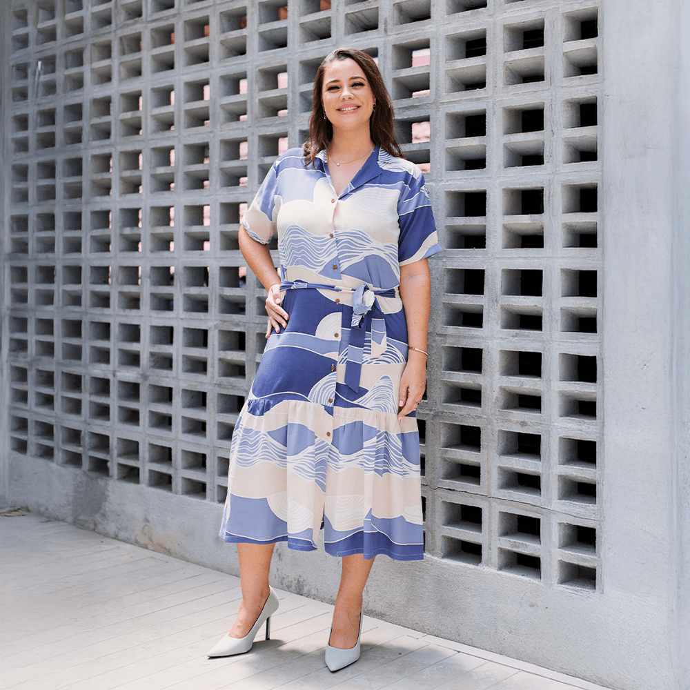 Woman wearing Batik Boutique’s Button-Up Dress in Lavender Bukit print, styled with heels for an effortless outdoor look.