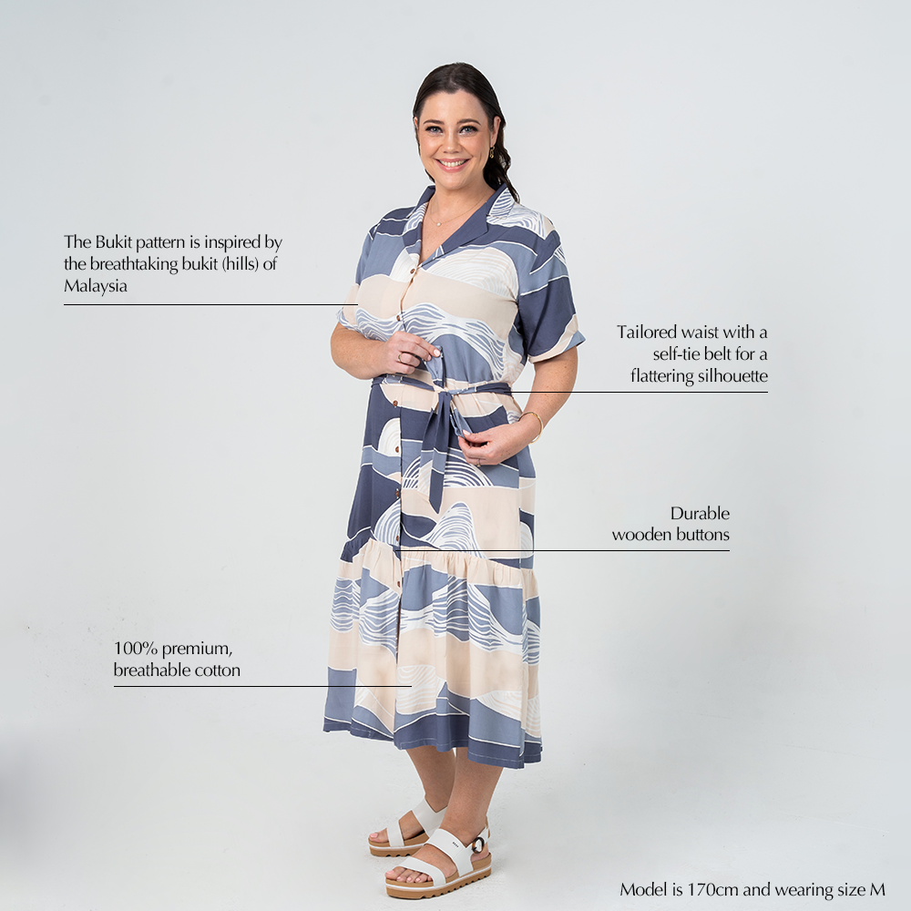 Batik Boutique’s Button-Up Dress in Lavender Bukit print, featuring premium cotton, artisan-inspired design, and customisable waist tie.