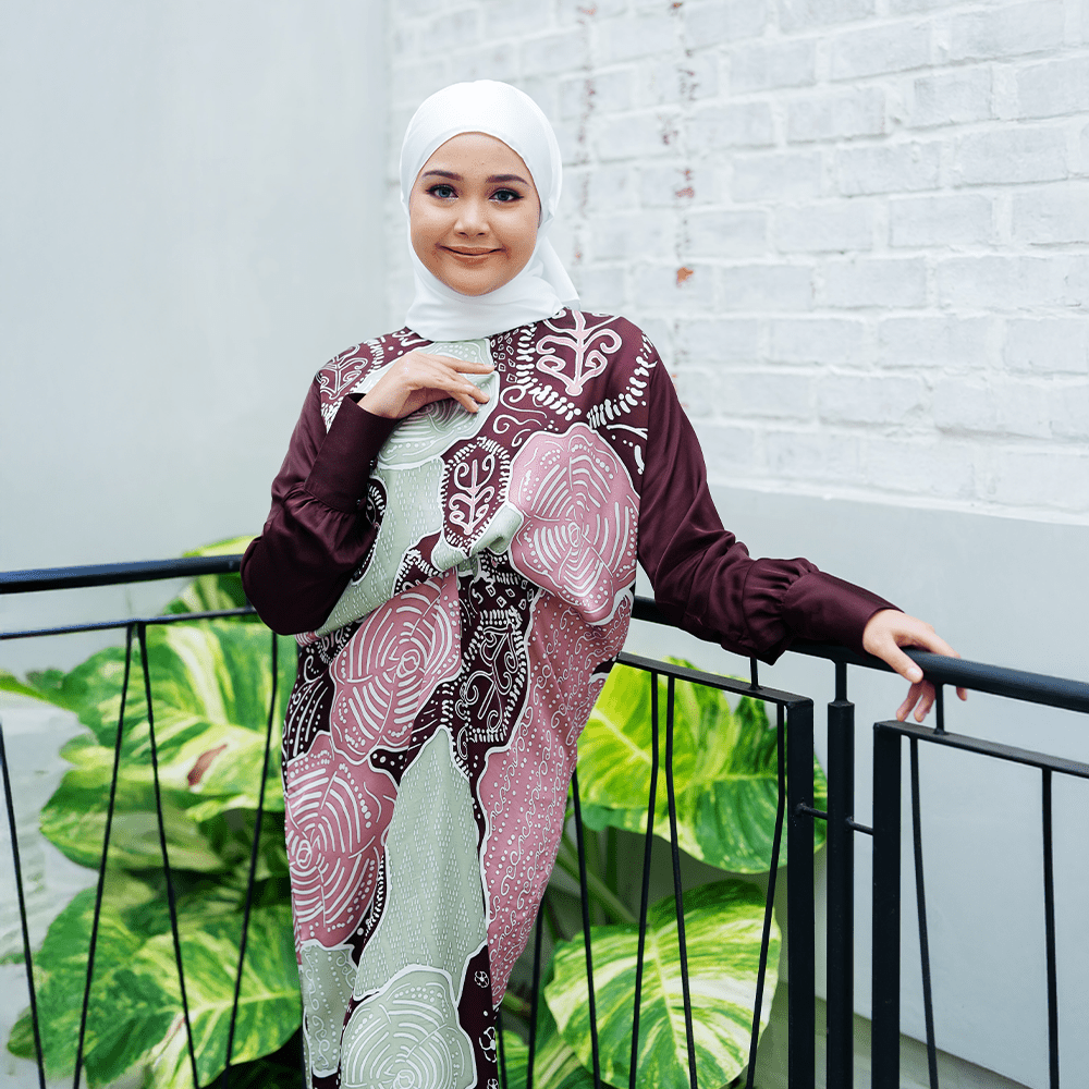 women wearing the Batik Caftan Pareo  in Maroon Petola in and outdoor balcony
