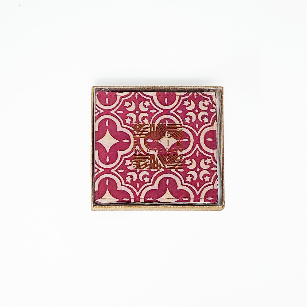 A whitebox photo of batik coaster in a box with golden stamping showing batik boutique logo