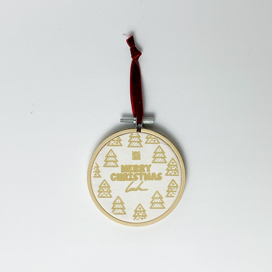 A whitebox photo of batik painting ornaments in "Merry Christmas" Pattern. With white paper as background