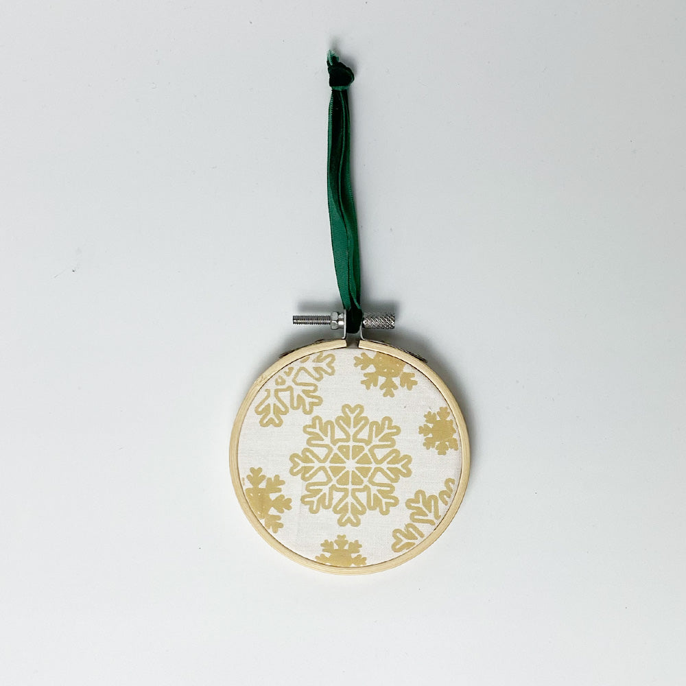 A whitebox photo of batik painting ornaments in "Snowflakes" Pattern. With white paper as background