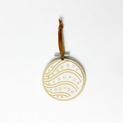 a whitebox photo of christmas ornament batik against a white background with velvet thread