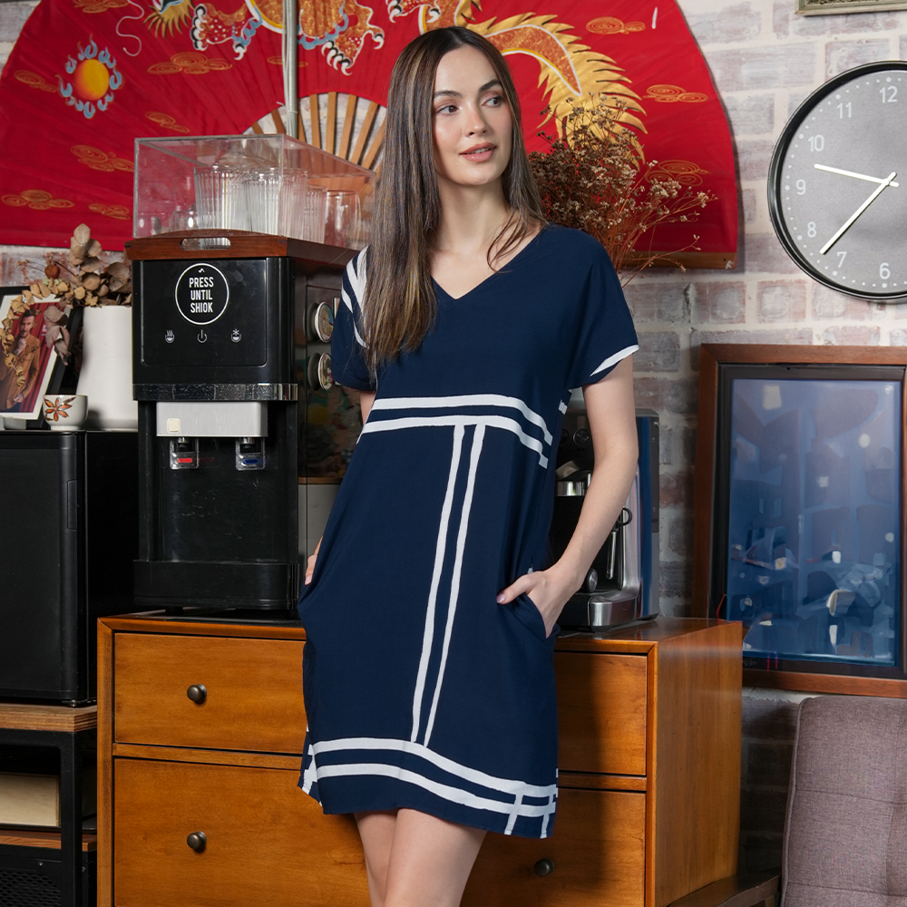 a woman dressed in a batik dress in a lifestyle photo in the pattern navy brush