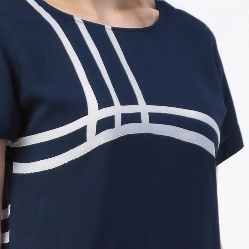 a closeup shot of a batik dress in the pattern navy brush in navy blue and white colors