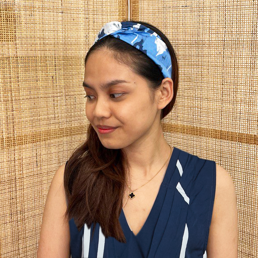 A model is wearing batik headband in ultra marine print. Made from batik remnant fabric