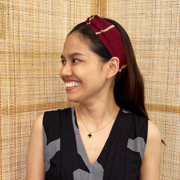  A model is wearing batik headband in crimson brush print. Made from batik remnant fabric