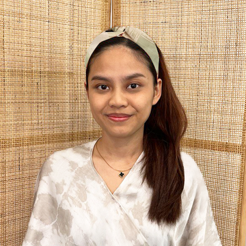 A model is wearing batik headband in brushed olive color. Made from batik remnant fabric