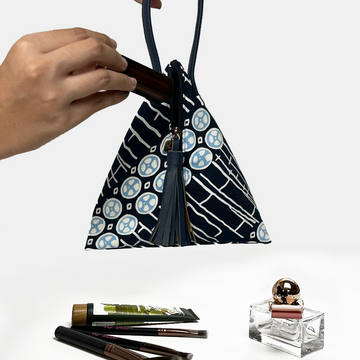 batik ketupat bag in the pattern navy buluh against a white background with props