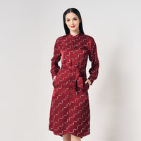 A women is wearing batik long shirt dress in crimson tangga pattern. Handmade and handcrafted by artisans in Malaysia