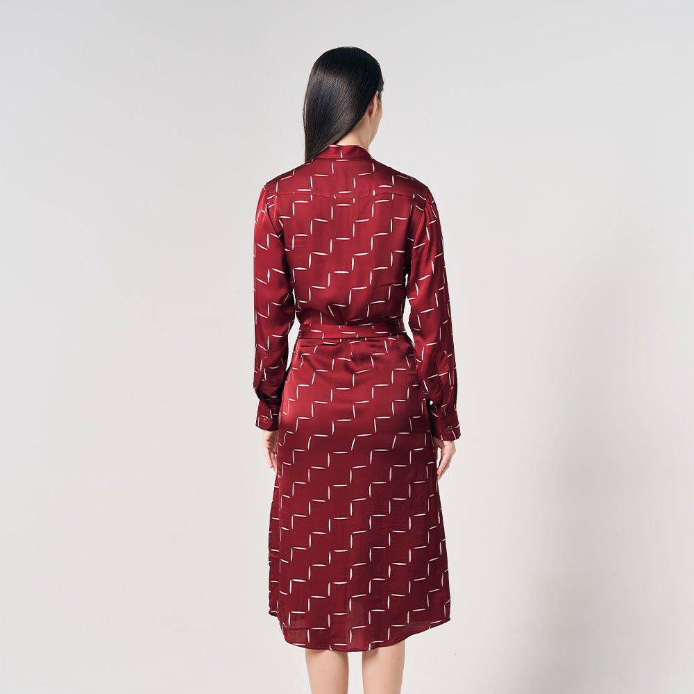 A photo of a model showcasing the back of a long shirt dress in the pattern crimson kimono