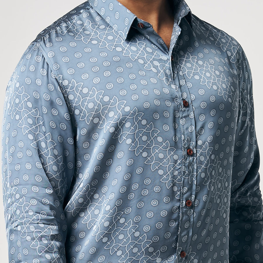 A closeup photo showing button on silk cotton long sleeve shirt in Slate Alur, which is bluish silver color. Shirt is handcrafted by skilled artisans