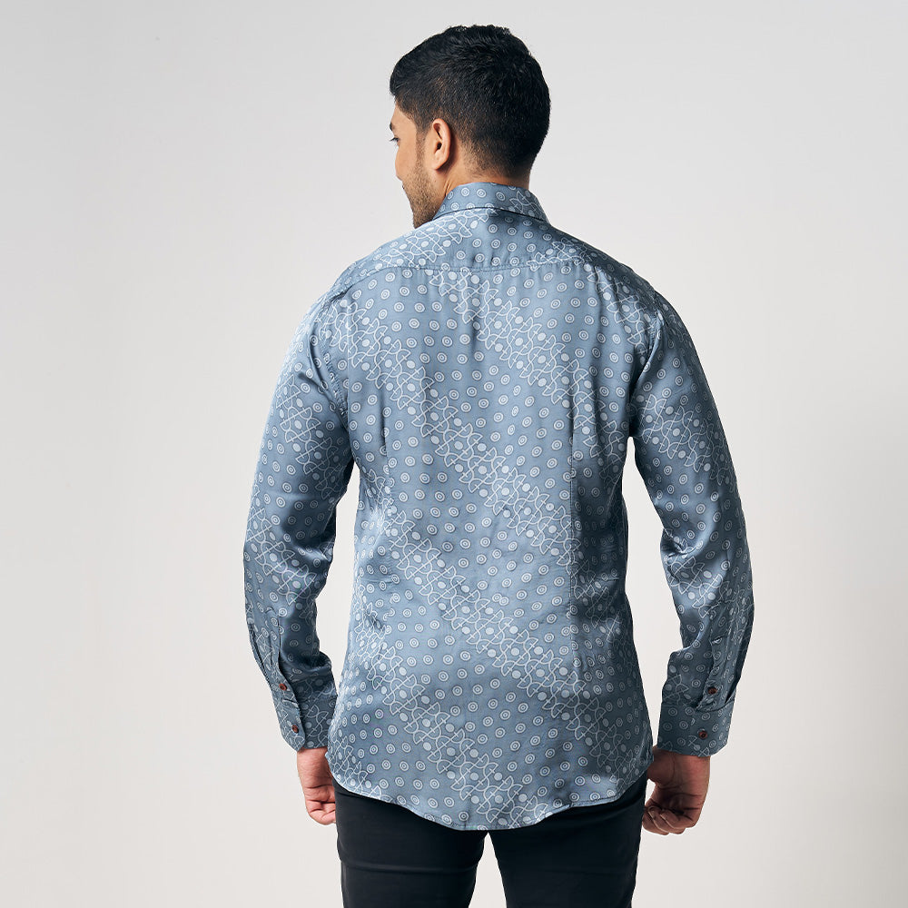 A man is wearing handcrafted batik long sleeve shirt in Slate Alur, blueish silver color shirt. While posing in front of white background
